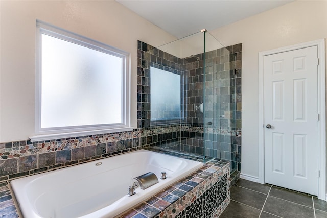 full bath featuring a bath, a shower stall, and tile patterned flooring