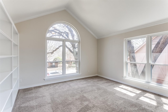 carpeted spare room featuring baseboards, lofted ceiling, and ornamental molding