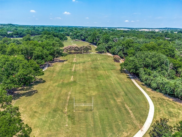 drone / aerial view with a wooded view