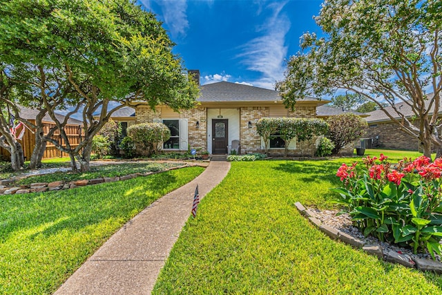 view of front of house with fence, a front lawn, and brick siding