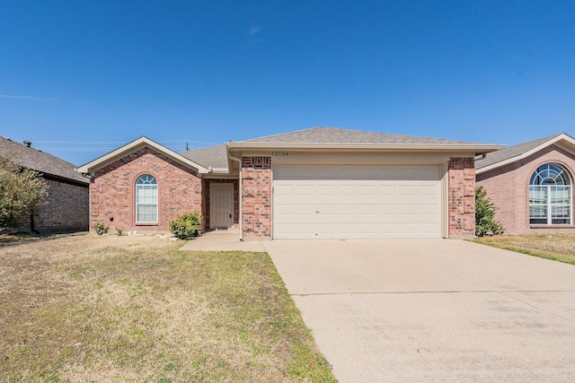 ranch-style house featuring brick siding, roof with shingles, concrete driveway, a front yard, and a garage