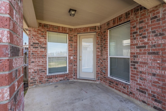 12104 Rolling Ridge Dr, Fort Worth, TX 76028 - property entrance featuring brick siding and a patio