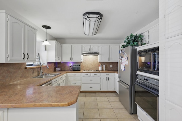 kitchen with a peninsula, a sink, white cabinets, black appliances, and decorative light fixtures