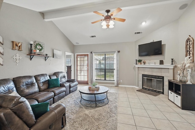 living area featuring light tile patterned floors, a fireplace, visible vents, and beamed ceiling