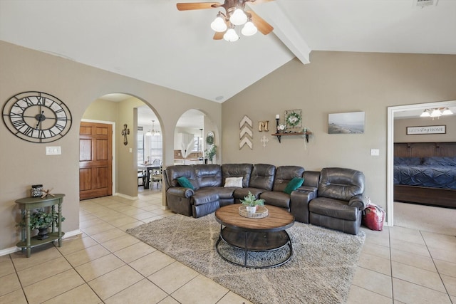 living room with vaulted ceiling with beams, light tile patterned floors, arched walkways, visible vents, and baseboards