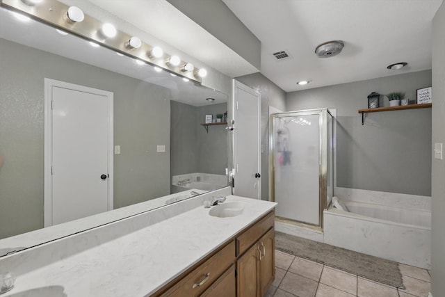 bathroom featuring tile patterned flooring, a sink, a shower stall, a bath, and double vanity