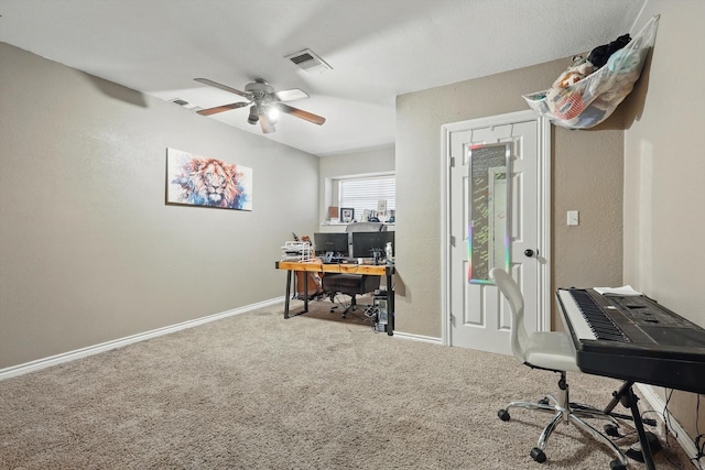 carpeted home office with a ceiling fan, visible vents, and baseboards