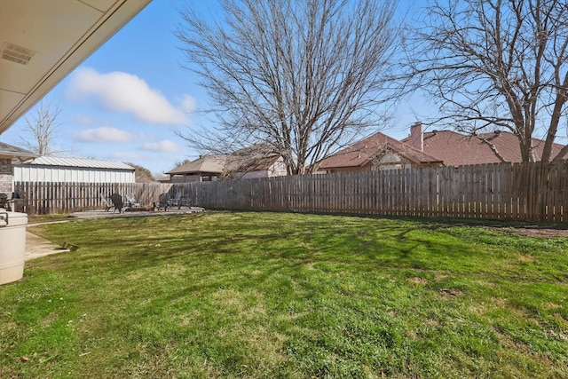 view of yard with a fenced backyard and a patio