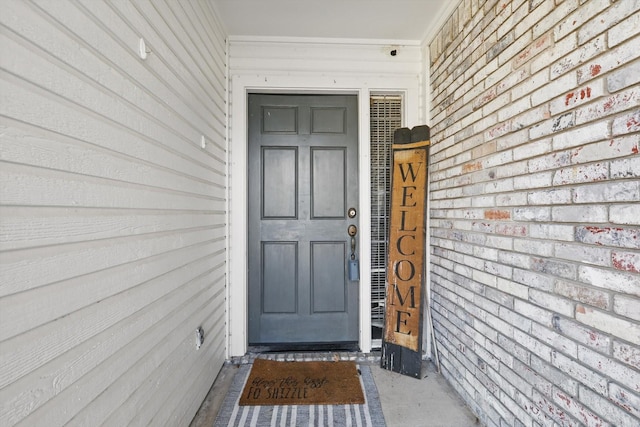 entrance to property with brick siding