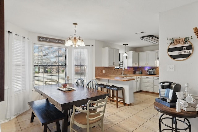 dining space featuring visible vents, an inviting chandelier, and light tile patterned floors