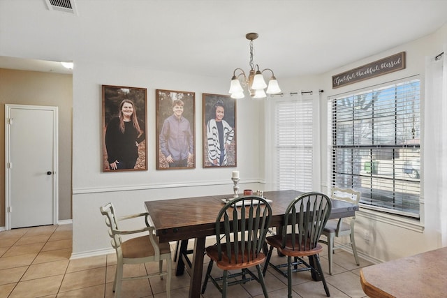 dining room with baseboards, visible vents, an inviting chandelier, and light tile patterned floors