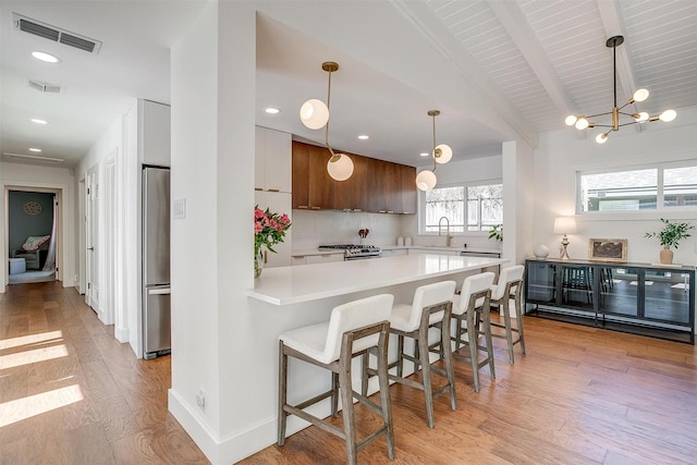 kitchen with light wood-style flooring, visible vents, light countertops, appliances with stainless steel finishes, and modern cabinets