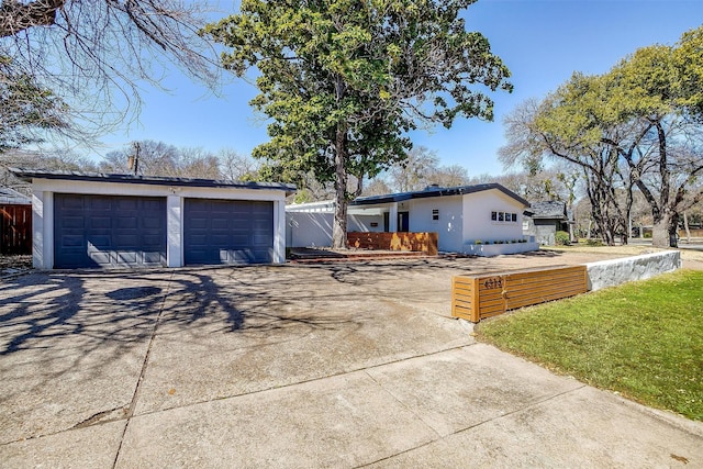 view of front of house with a detached garage and stucco siding