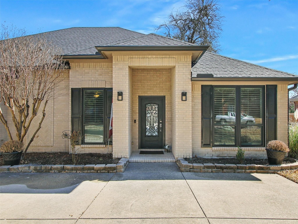 9604 Southern Hills Dr, Plano, TX 75025 - property entrance with brick siding and a shingled roof
