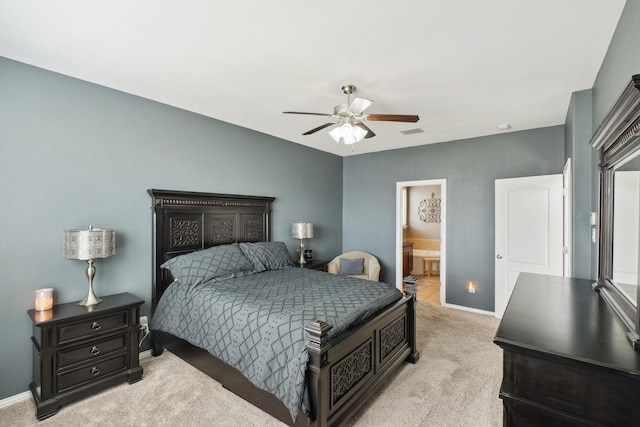 bedroom with visible vents, baseboards, ensuite bath, ceiling fan, and light colored carpet