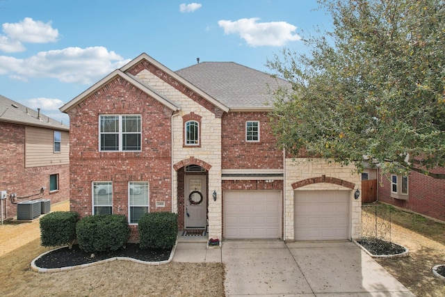 view of front of property featuring concrete driveway, an attached garage, a shingled roof, brick siding, and central AC unit