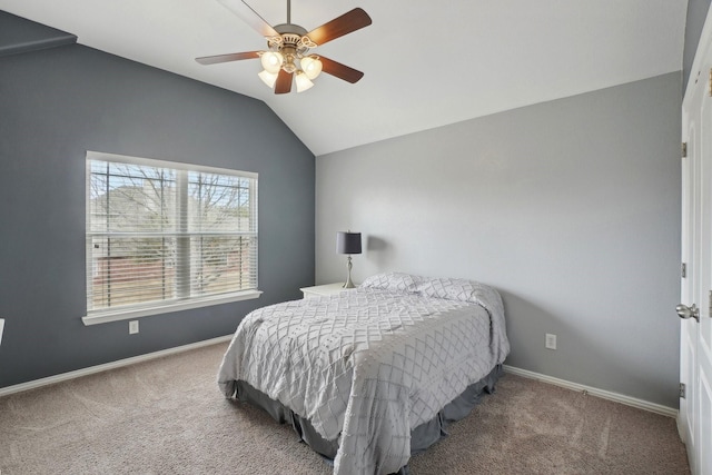 carpeted bedroom featuring baseboards, lofted ceiling, and a ceiling fan