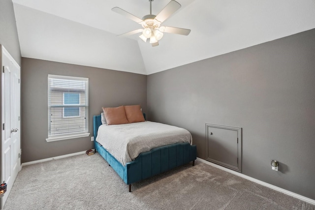 bedroom with baseboards, carpet floors, lofted ceiling, and a ceiling fan