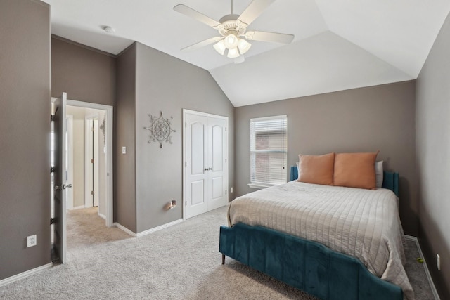 bedroom featuring baseboards, carpet floors, lofted ceiling, ceiling fan, and a closet