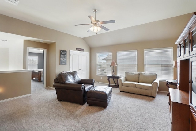 living area featuring vaulted ceiling, a ceiling fan, baseboards, and carpet floors