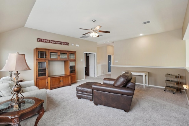 living room featuring baseboards, visible vents, lofted ceiling, ceiling fan, and light carpet