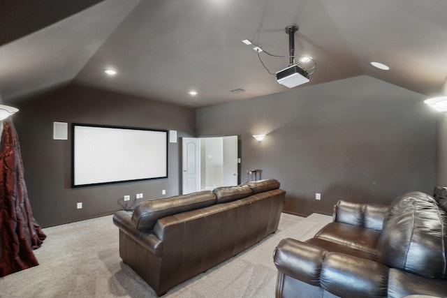 cinema room featuring light carpet, baseboards, and vaulted ceiling