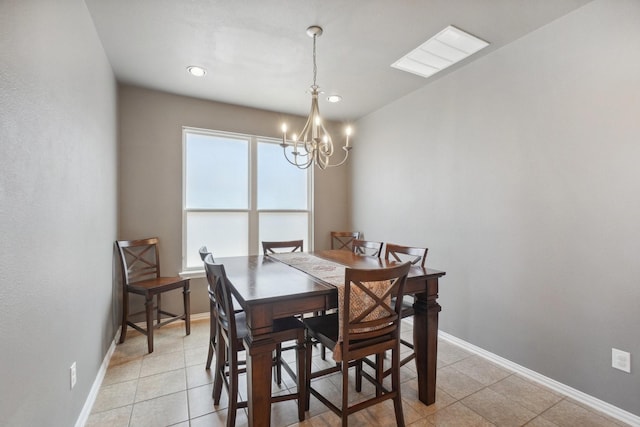 dining room with light tile patterned floors, baseboards, and a notable chandelier