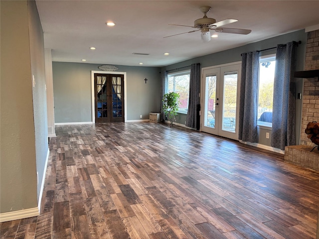 unfurnished living room with recessed lighting, french doors, baseboards, and wood finished floors