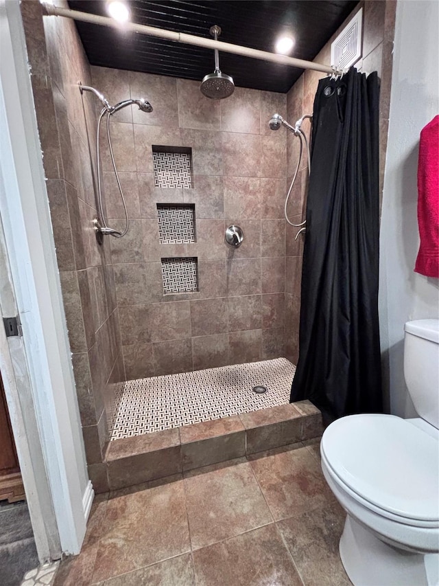 full bath featuring visible vents, a shower stall, and toilet