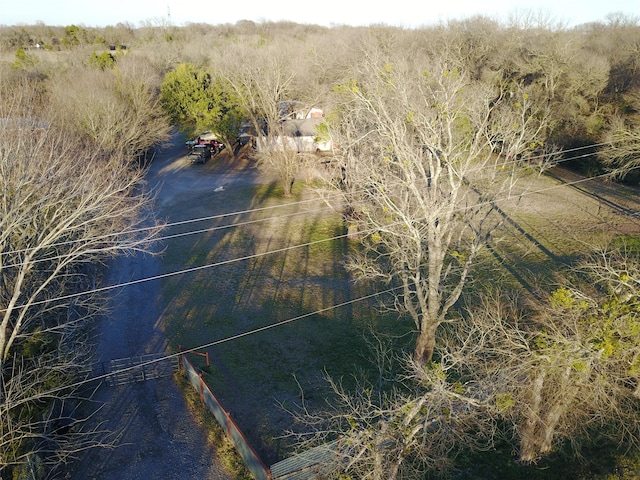 drone / aerial view featuring a view of trees