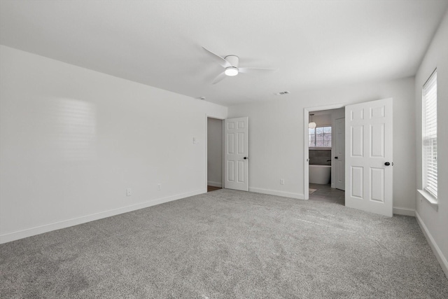 unfurnished bedroom featuring carpet, a ceiling fan, and baseboards