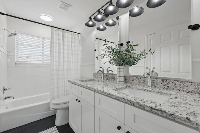 bathroom featuring visible vents, a sink, toilet, and tile patterned floors