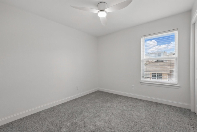 empty room featuring carpet, a ceiling fan, and baseboards