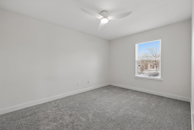 unfurnished room featuring carpet flooring, a ceiling fan, and baseboards