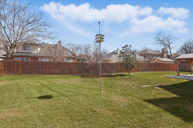 view of yard featuring a fenced backyard and a gazebo