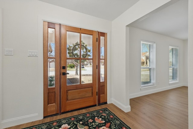 entryway featuring wood finished floors and baseboards