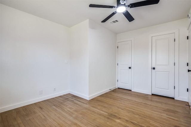 unfurnished bedroom featuring visible vents, ceiling fan, light wood-style flooring, and baseboards