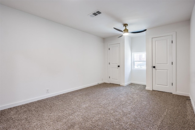 unfurnished bedroom with carpet floors, baseboards, visible vents, and a ceiling fan