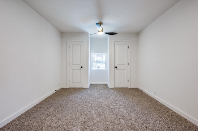 unfurnished room featuring a ceiling fan, carpet flooring, and baseboards