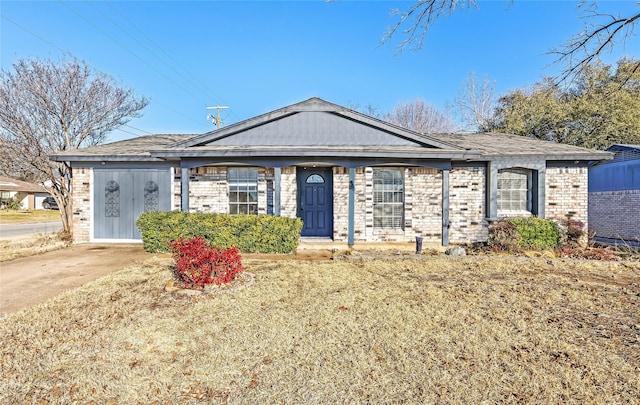 ranch-style house with a front yard and brick siding