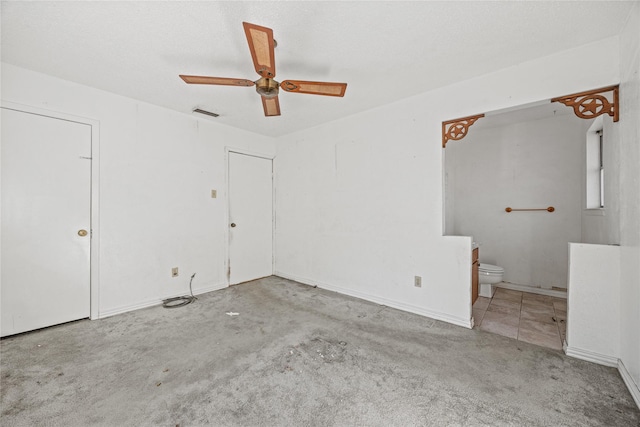 unfurnished bedroom with light carpet, visible vents, a ceiling fan, connected bathroom, and a textured ceiling