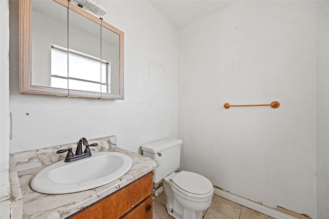 bathroom with vanity, toilet, and tile patterned floors