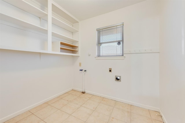 washroom with light tile patterned floors, laundry area, electric dryer hookup, and baseboards