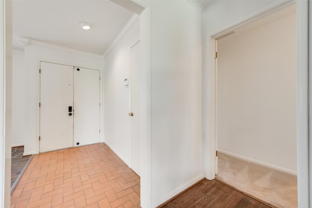 entryway featuring crown molding and baseboards