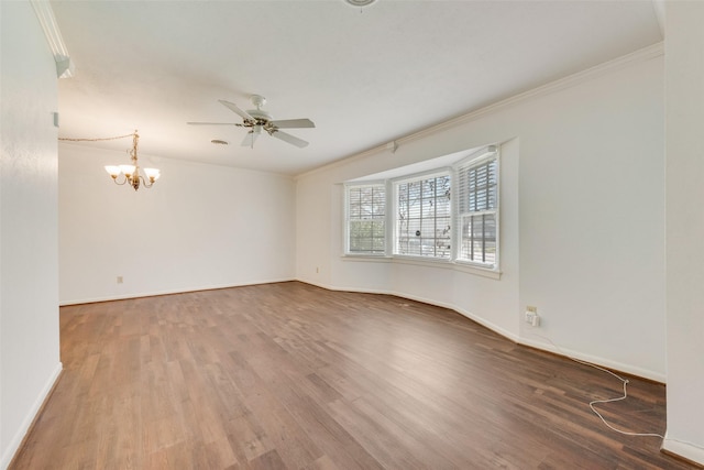 unfurnished room with crown molding, baseboards, and wood finished floors