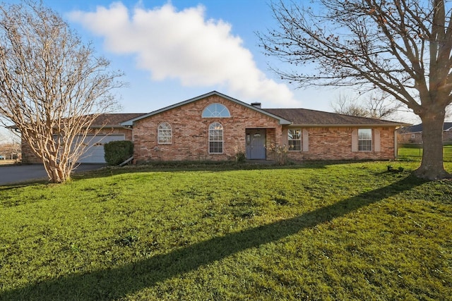 ranch-style house with driveway, brick siding, a front lawn, and an attached garage