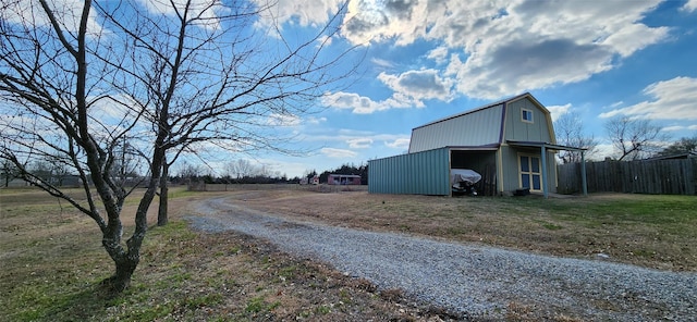 view of street featuring driveway and a pole building