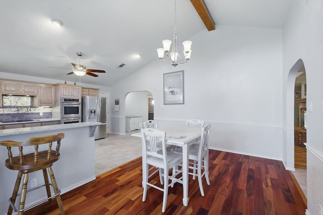dining room featuring visible vents, arched walkways, ceiling fan with notable chandelier, and lofted ceiling with beams