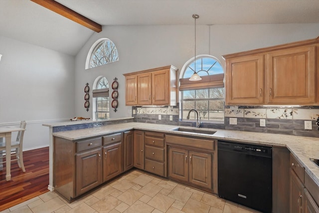 kitchen with beamed ceiling, a sink, black dishwasher, tasteful backsplash, and a peninsula