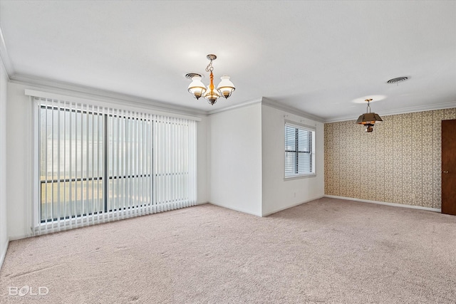 unfurnished room with carpet, ornamental molding, a chandelier, baseboards, and wallpapered walls